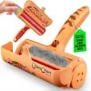 Limited edition cat design ChomChom roller with the lid open, revealing a chamber full of trapped gray fur and the brush mechanism.