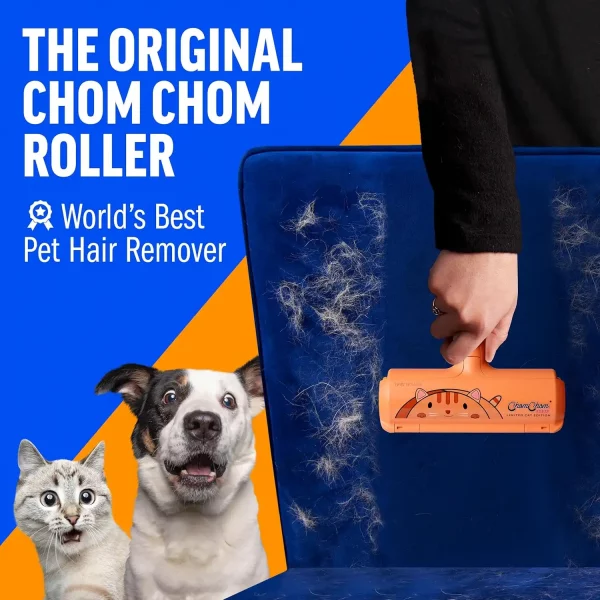 A hand rolling the original ChomChom device on a blue velvet chair to clear thick white pet hair, with surprised dogs and a cat in the background.