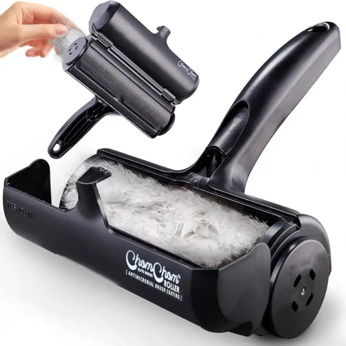 A close-up view of the device opened up to reveal the waste compartment filled with collected white fur, displaying the internal brush mechanism