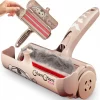 pet-hair-roller-open-waste-chamber-mechanism Product detail shot showing the roller with the waste door open, revealing a chamber full of collected grey fur and the internal red brush mechanism.