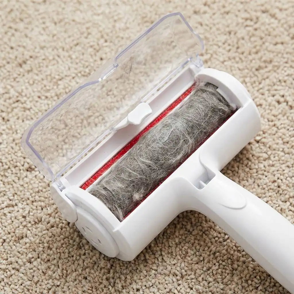 Compressed cylinder of grey dog hair and dust inside the open waste compartment of a cleaning tool on a beige carpet.
